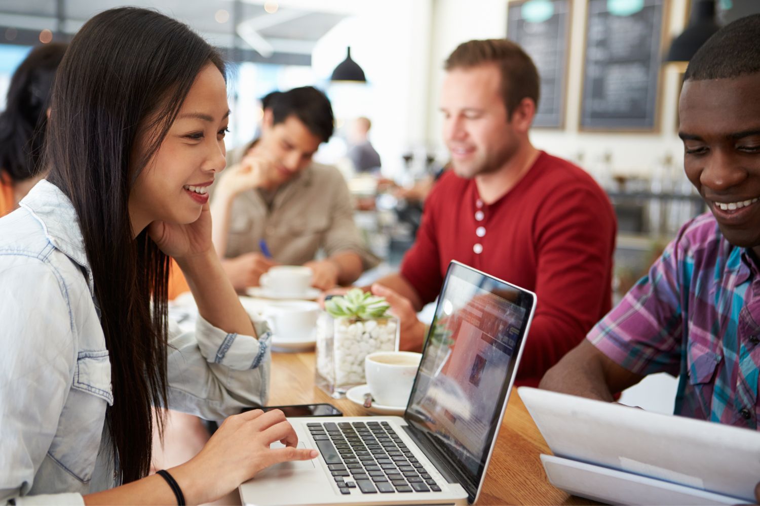 working at a cafe on a laptop image