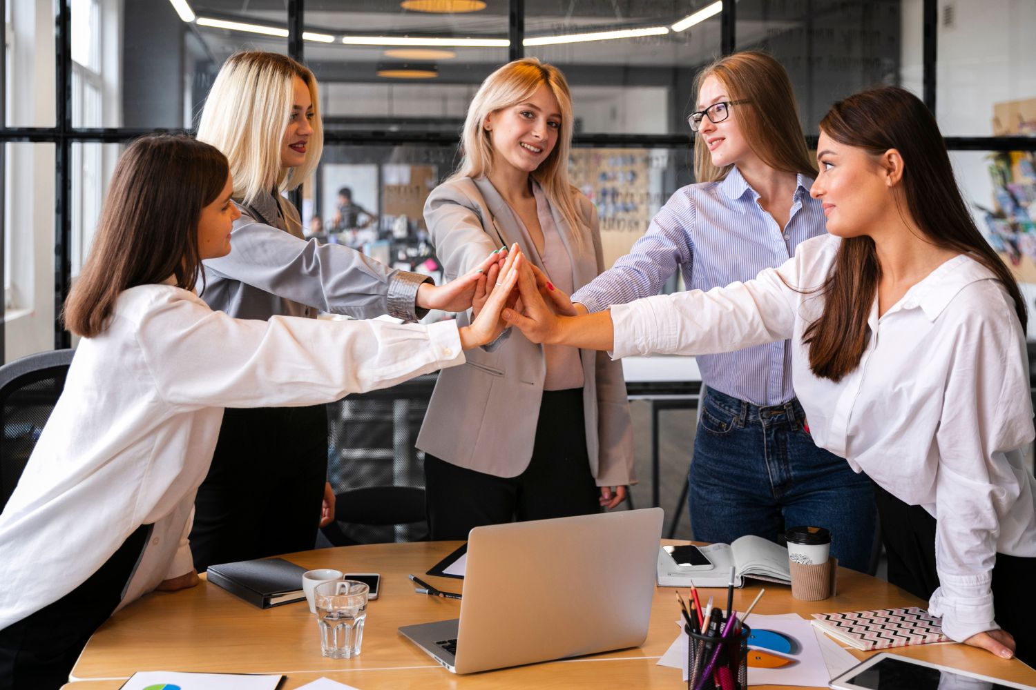 businesswomen team high five
